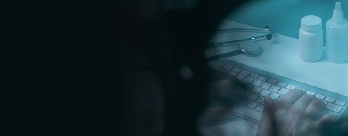 Doctor working at computer keyboard through X-ray film