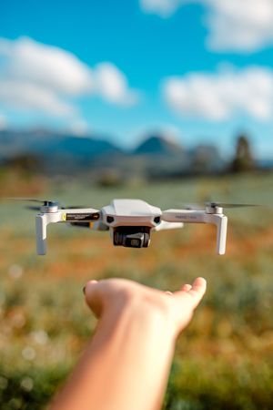 Drone flying above a person's hand outdoor