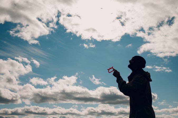 Silhouette of a man under blue sky
